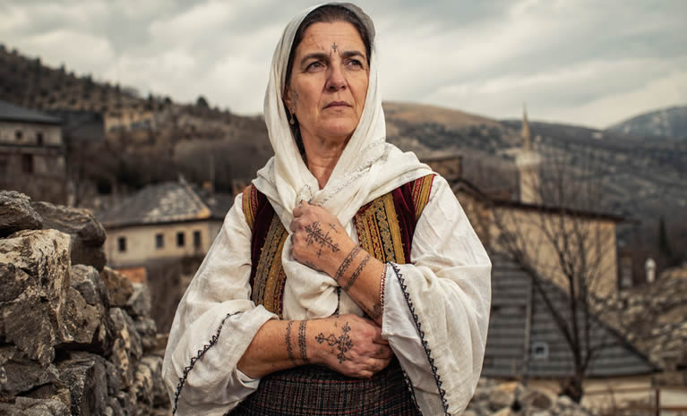 Sicanje, tradicionalno tetoviranje Hrvatica katolkinja u Bosni i Hercegovini, nije bilo ukras nego znak pripadnosti, vjere i otpora. Na rukama prabaka, baka i majki ostali su križevi, ograde, kola i narukvice — tihi arhivi vremena u kojem se identitet često morao braniti tijelom. Stoljećima kasnije, taj se zaboravljeni ženski znak pojavio na eurovizijskoj pozornici kroz pjesmu “Andromeda”, kao kruna jedne duge šutnje.